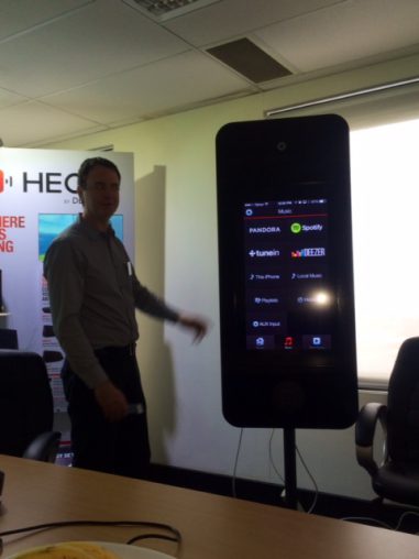 An admitedly poor photograph of Nick Murrells demonstrating the Heos by Denon app.
