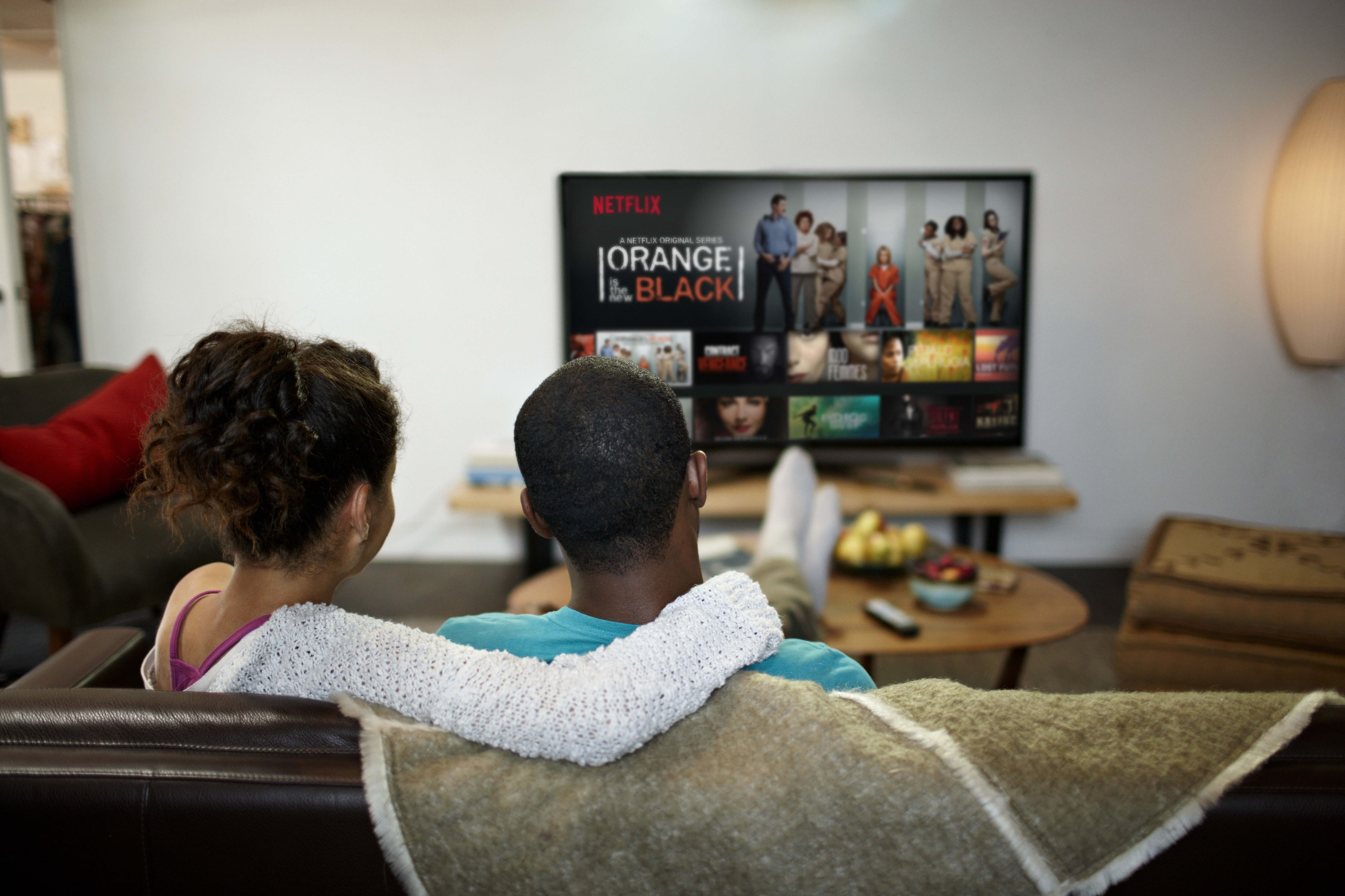 A family enjoys Netflix on TV, just one of many devices that carries the service.